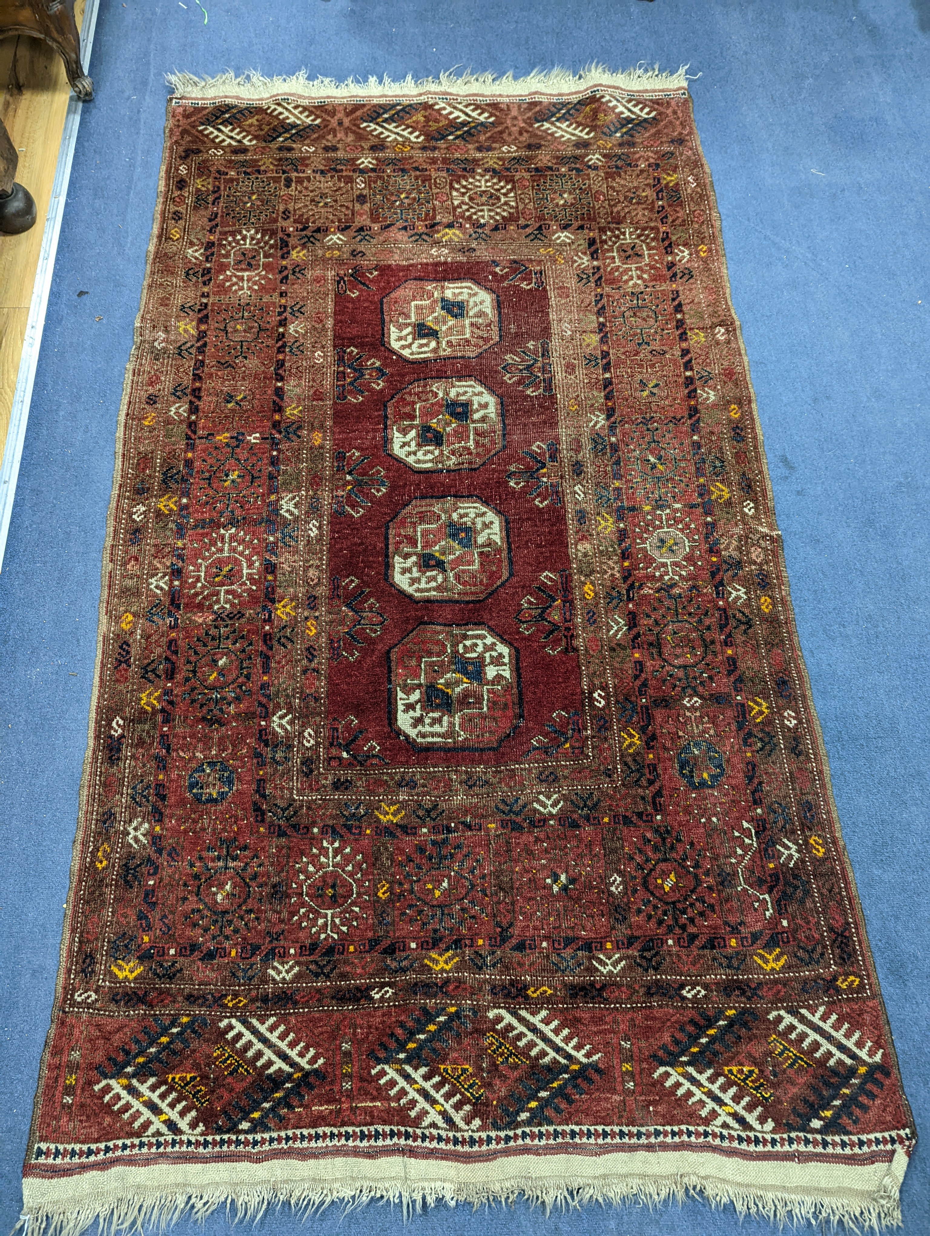 A Bokhara red ground rug, 200 x 114cm
